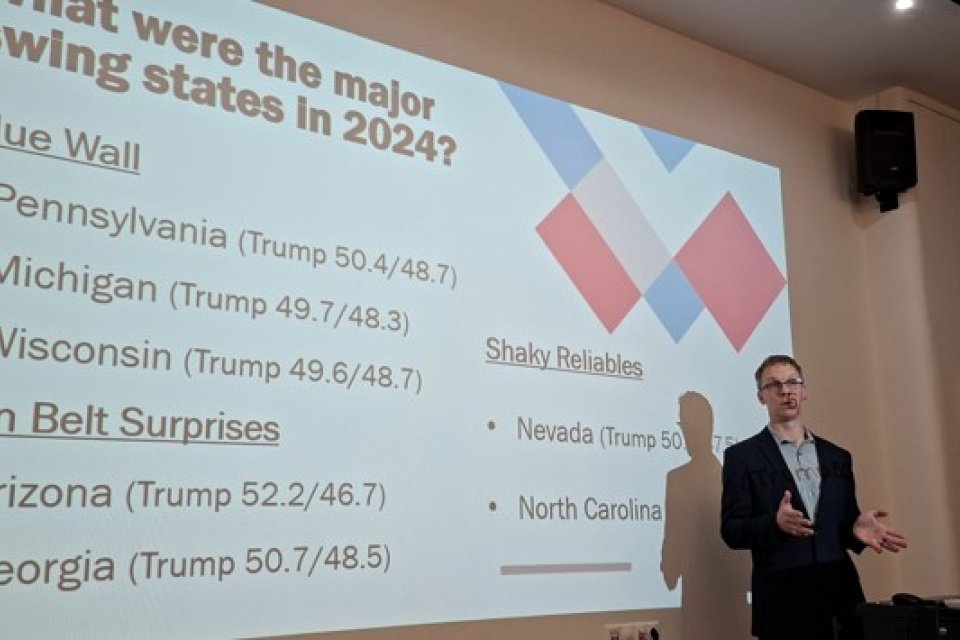 Professor Luke Perry lectures in front of a slide presentation at the University of Debrecen in Eastern Hungary.